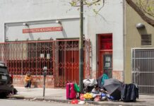 Demetrius McCray outside Tenderloin Housing Clinic with belongings on sidewalk