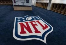 NFL Star’s Chilling Threat Admission NFL logo on the floor of an empty locker room