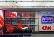 Inside Amanpour’s 2027 Power Move CNN newsroom set with red chairs and multiple TVs