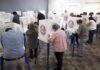20,000 ‘Likely’ Noncitizens? Show The Proof Voters fill out ballots at polling booths in a busy voting room
