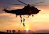 Air Force Identifies Airman Killed in Stadium Fall military helicopter with soldiers fast-roping at sunset