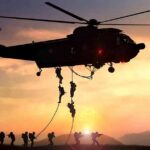 Air Force Identifies Airman Killed in Stadium Fall military helicopter with soldiers fast-roping at sunset