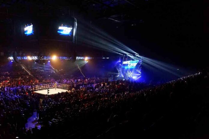 Wrestling ring in a packed arena with stage lights