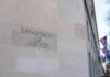 Campus Threats Trigger Federal Takedown Department of Justice building exterior with American flags