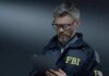 FBI Nabs Alleged China Agent At LAX FBI agent in jacket using a tablet