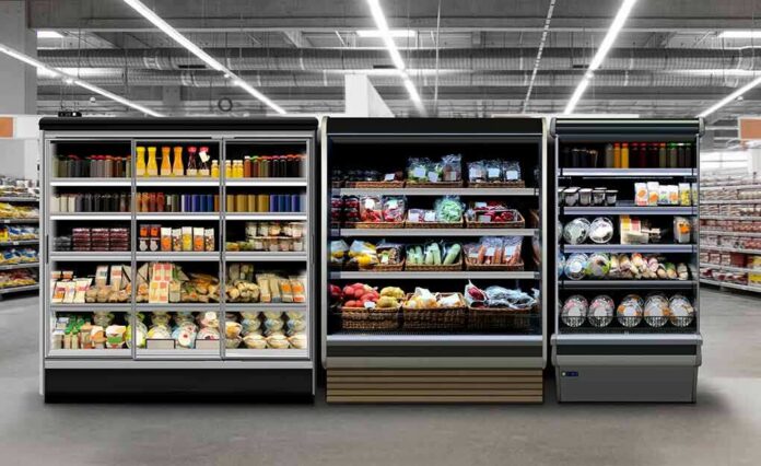 Supermarket refrigerated display cases with drinks, produce, and prepared foods