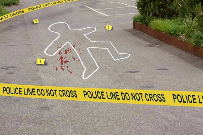 shutterstock_1754536016-1 crime scene with body outline and police tape