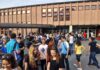 A Bible Education Dispute Ends in Costly Settlement Students gathered outside a school building entrance