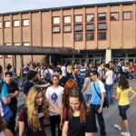 A Bible Education Dispute Ends in Costly Settlement Students gathered outside a school building entrance