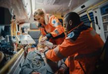 Paramedics treating a patient inside an ambulance
