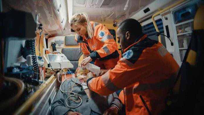 Paramedics treating a patient inside an ambulance