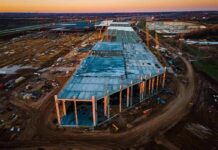 Google Bulldozers STOPPED Cold In Finland aerial view of large industrial building under construction at sunset