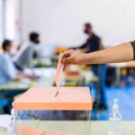 Venezuela Playbook Exposes E-Vote Weak Spot Hand casting ballot into a box at a polling station