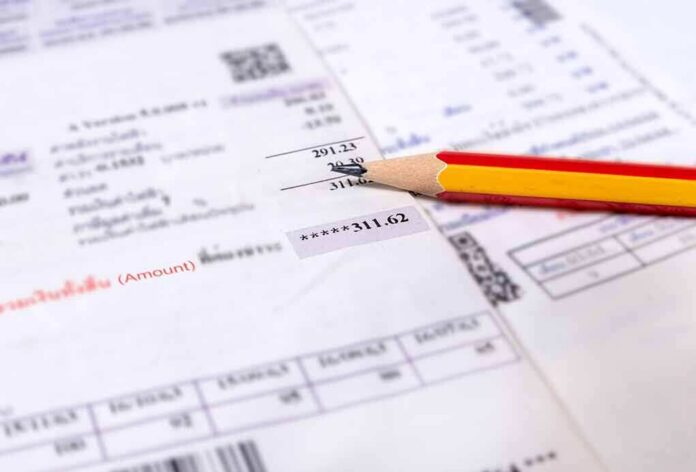 red and yellow pencil on printed bills and receipts