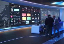 K – 12 Data Pipeline Springs a Gaping Leak cybersecurity operations room with large data dashboards and people discussing