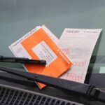 Placard Privilege Dirties NYC parking ticket under windshield wiper