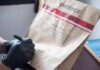 Gloved hands labeling a sealed evidence bag