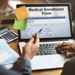 An Address Link Is Not Proof of Fraud Laptop displaying a medical enrollment form with two people reviewing it