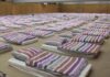 400,000 Homes Short: Dutch Housing Tensions Persist rows of mattresses with striped bedding in a large hall