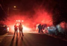Motel Standoff After Face Set Ablaze Firefighters and police at a nighttime car fire scene