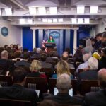 Five-Day Freefall Shocks White House Press secretary at podium addressing reporters in briefing room