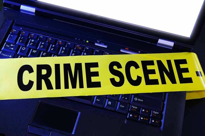 Laptop keyboard with yellow crime scene tape across it
